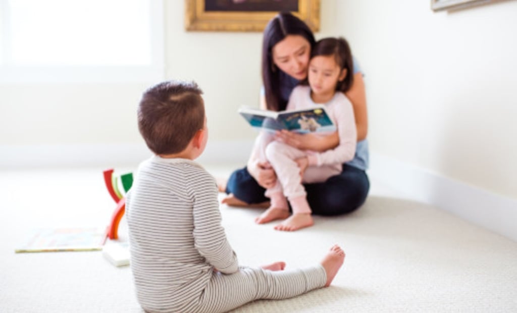 Mom reading a book to kids