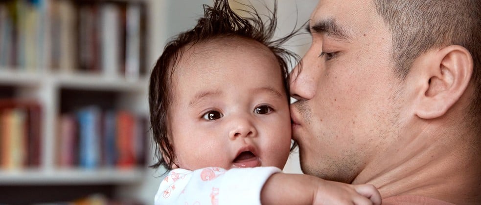 Dad kissing baby after bath time